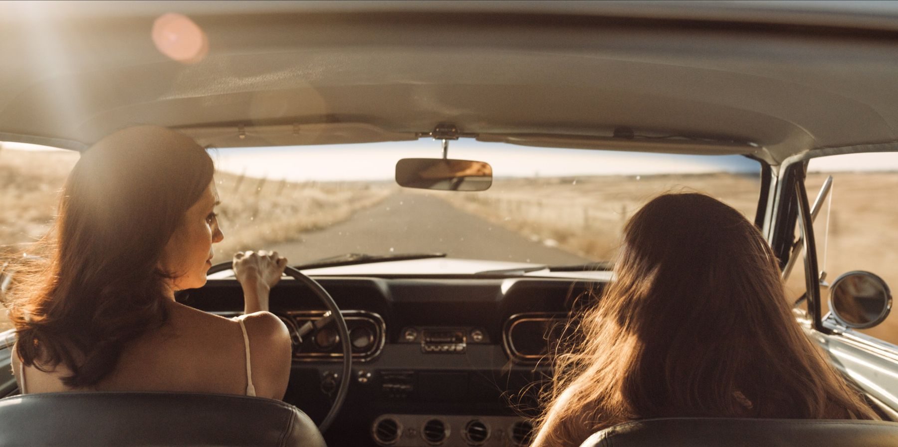 From the back seat: two women and the open road ahead